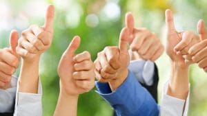 Several hands extended with thumbs up