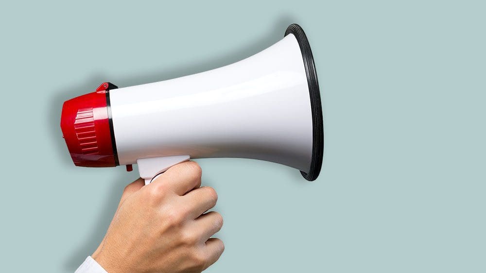 Hand holding a megaphone