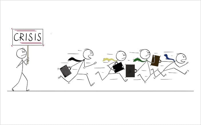 Business people stick figures running followed by stick figure holding a sign that says Crisis.