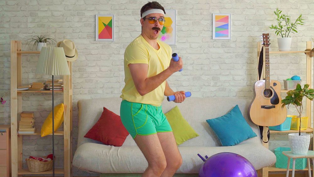 Man in goofy old style exercise gear works out with 1 pound weights